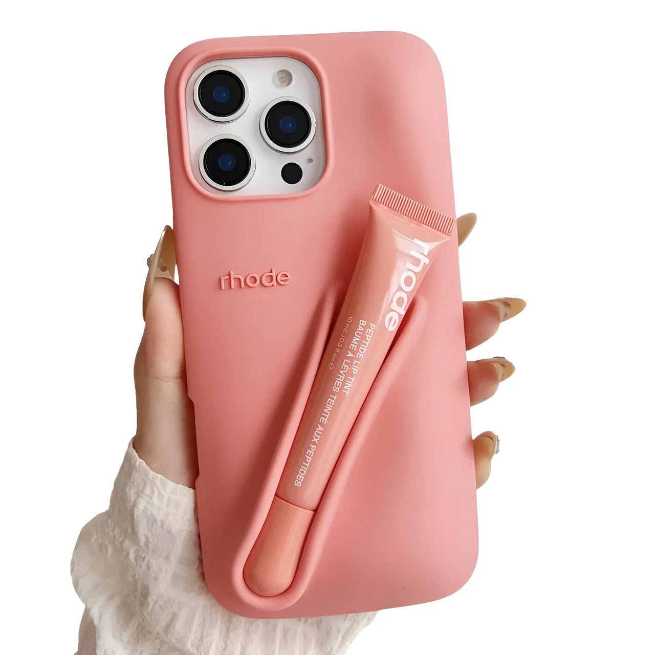 Pink silicone lipstick iPhone case with a matching lip balm held by a hand on a white background