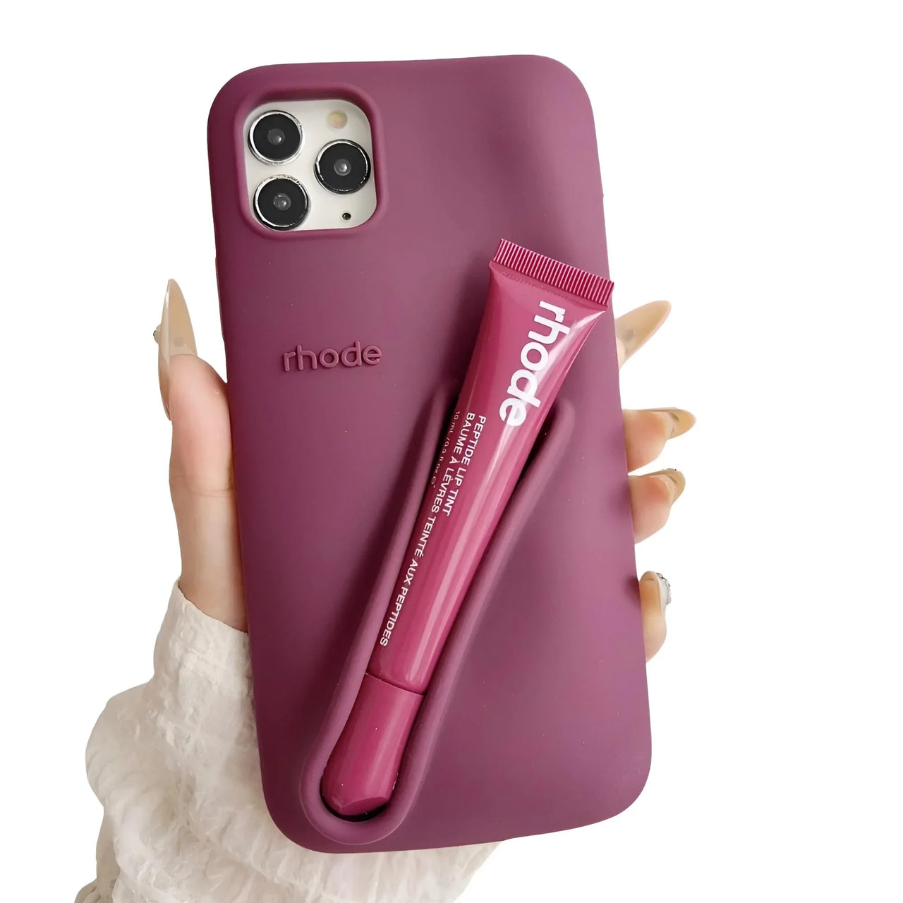 Purple silicone iPhone case with a matching lip balm held by a hand on a white background