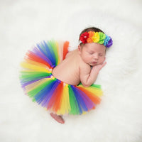 Thumbnail for Newborn baby wearing a rainbow tutu and headband on a white background