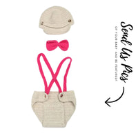 Thumbnail for Crocheted baby outfit with pink suspenders, bow tie, and cap on a white background.