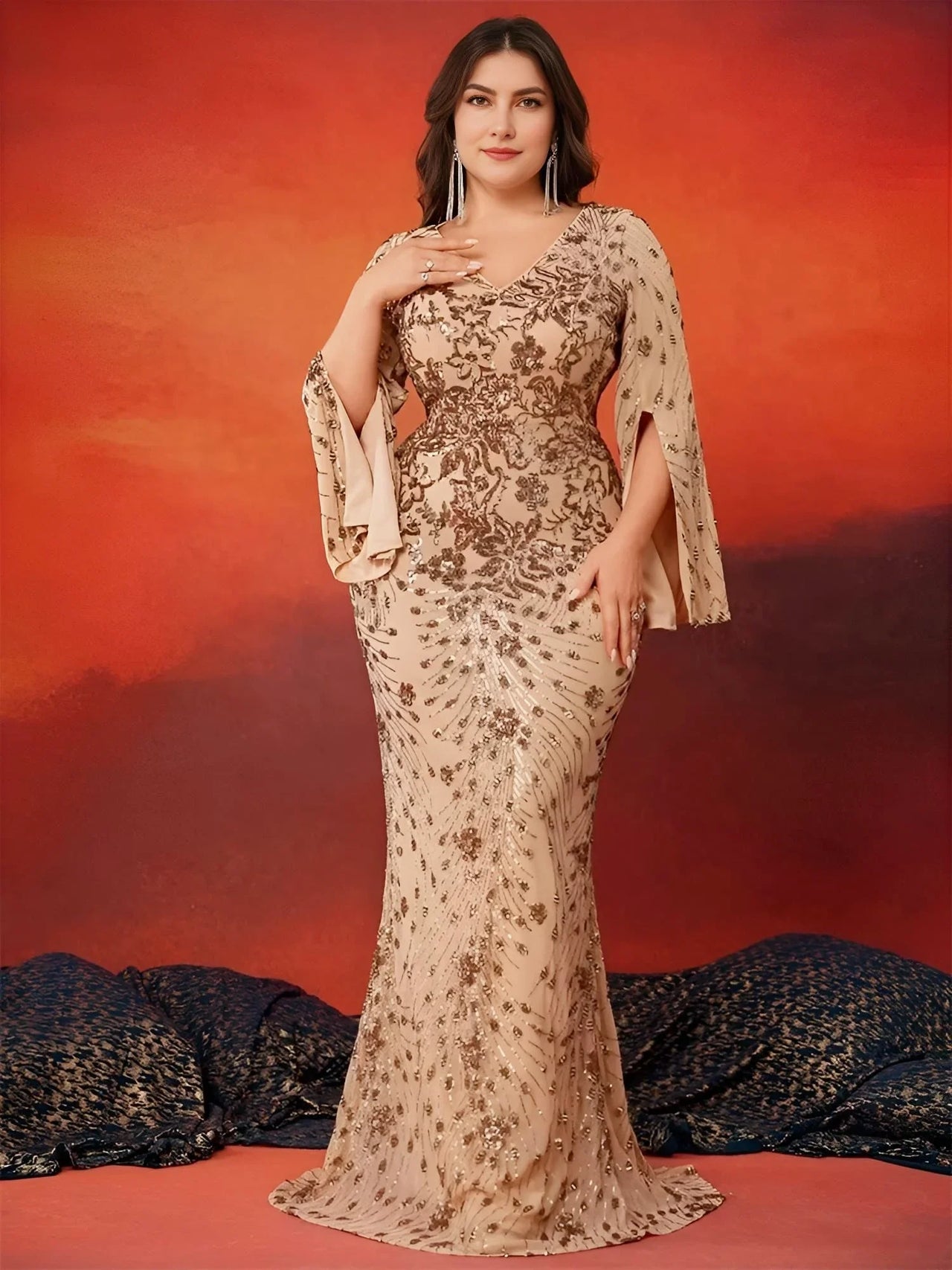 Woman in a plus size floral evening gown against an orange and red background