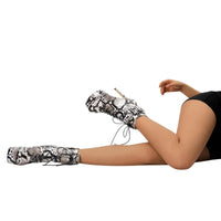 Thumbnail for Snakeskin-patterned high-heeled boots worn by a person on a white background