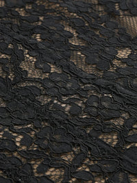 Thumbnail for Close-up of black sheer lace dress fabric with intricate floral pattern on a white background