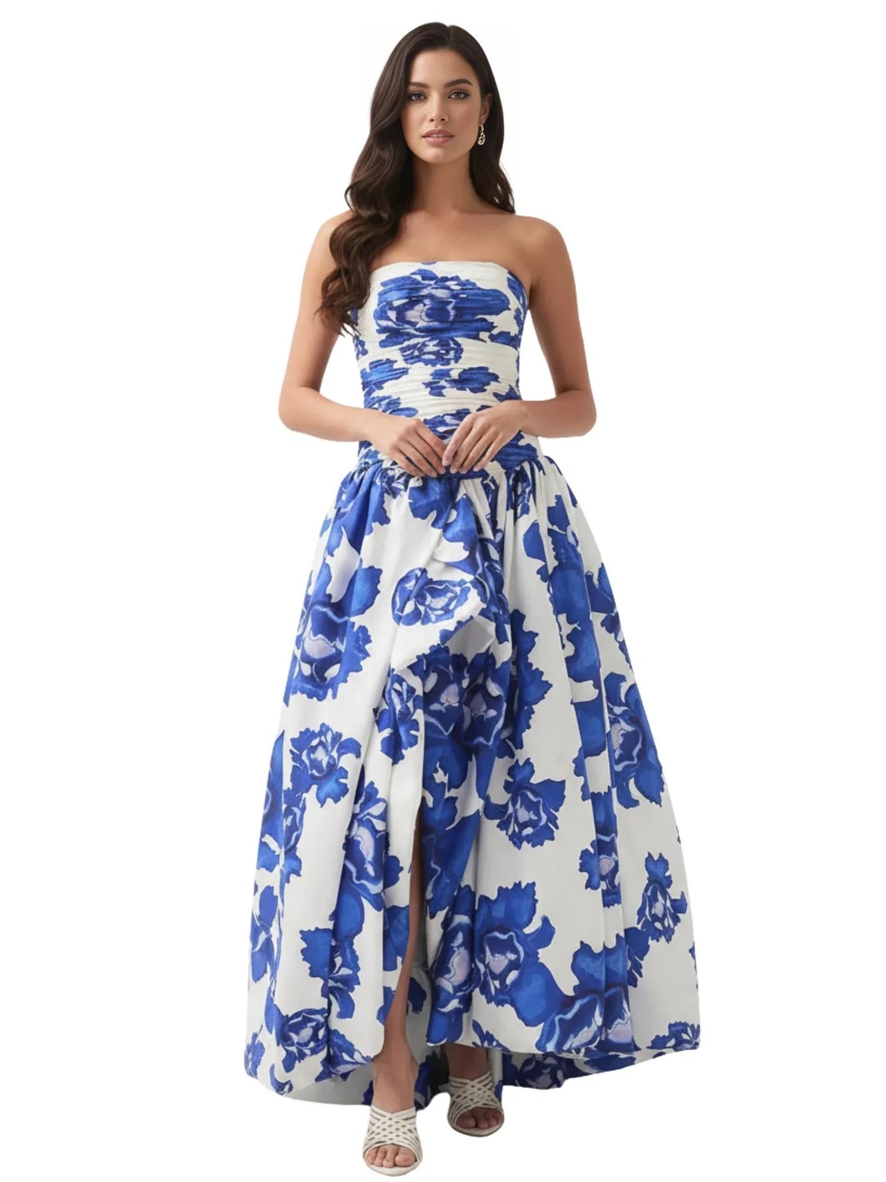 Woman wearing a blue floral strapless long bubble dress with a high slit on a white background