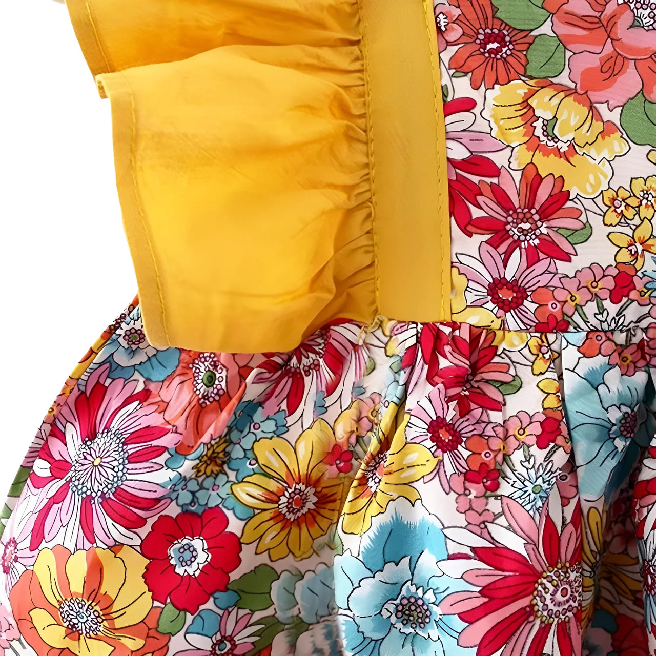 Close-up of a colorful floral dress with a yellow ruffle sleeve.