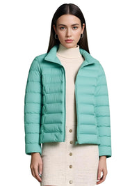 Thumbnail for Woman wearing a light blue puffer jacket on a white background