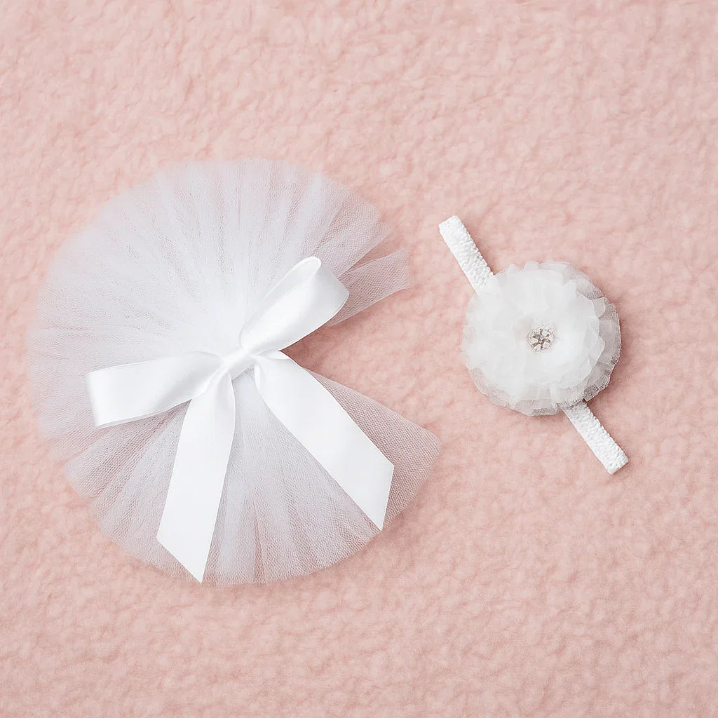 White tutu and headband set on a pink textured background