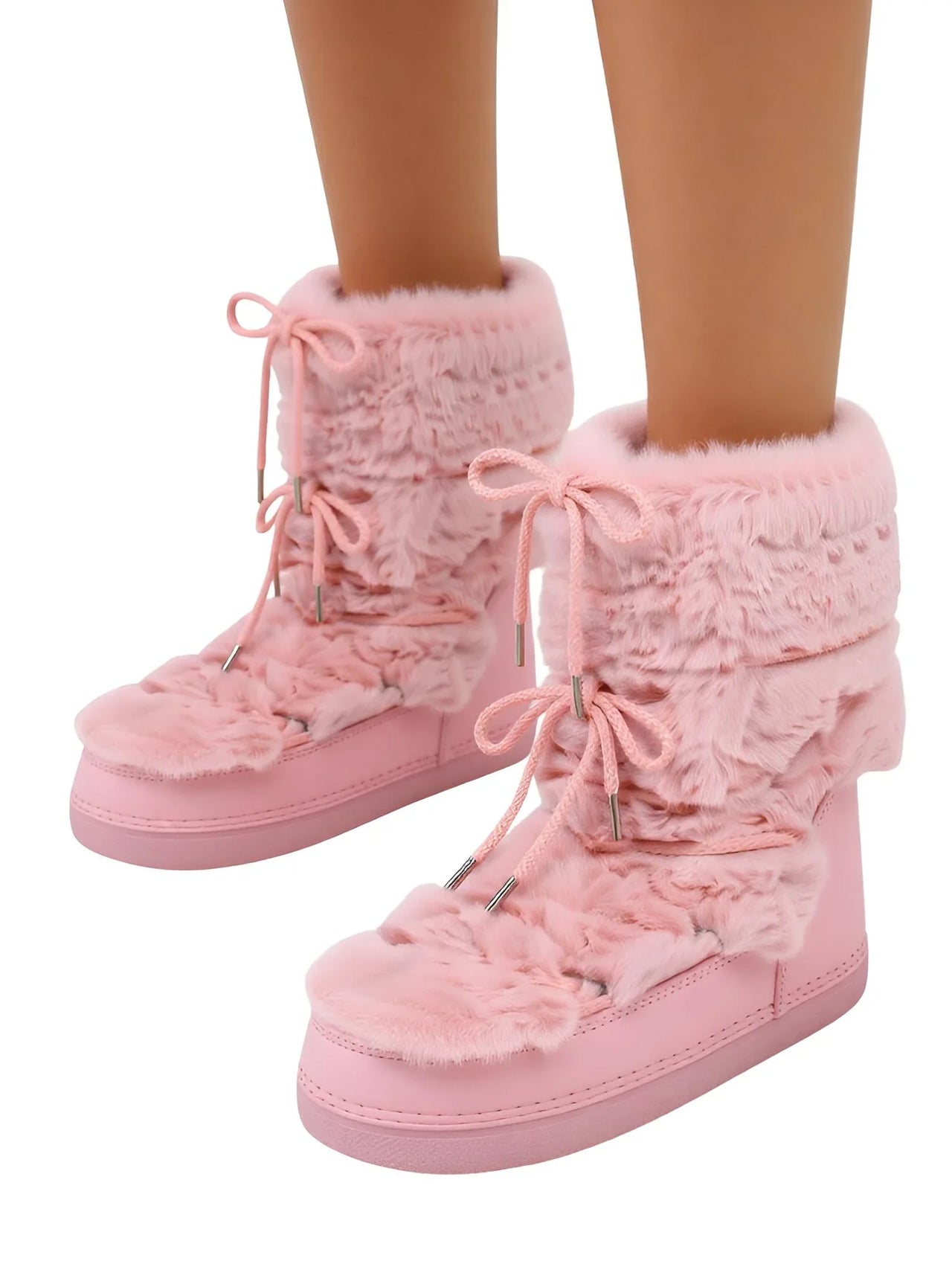 Pink fuzzy boots with laces on a white background