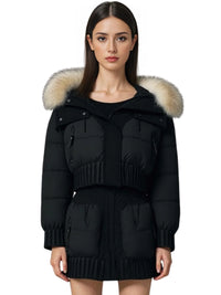 Thumbnail for Woman wearing a black puffer jacket with a large fur hood on a white background