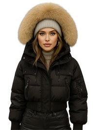 Thumbnail for Woman wearing a black puffer jacket with a fur-lined hood on a white background