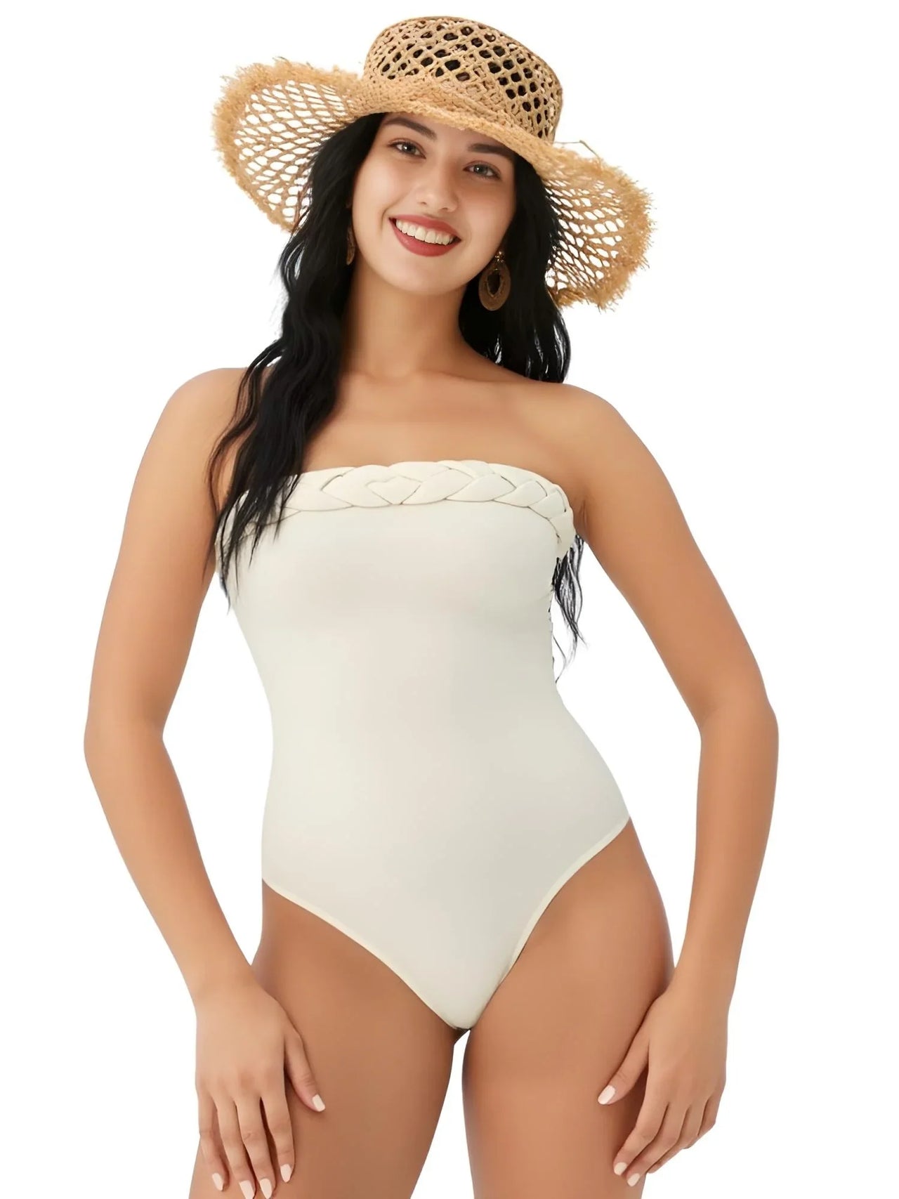 Woman wearing a white strapless swimsuit and straw hat on a white background