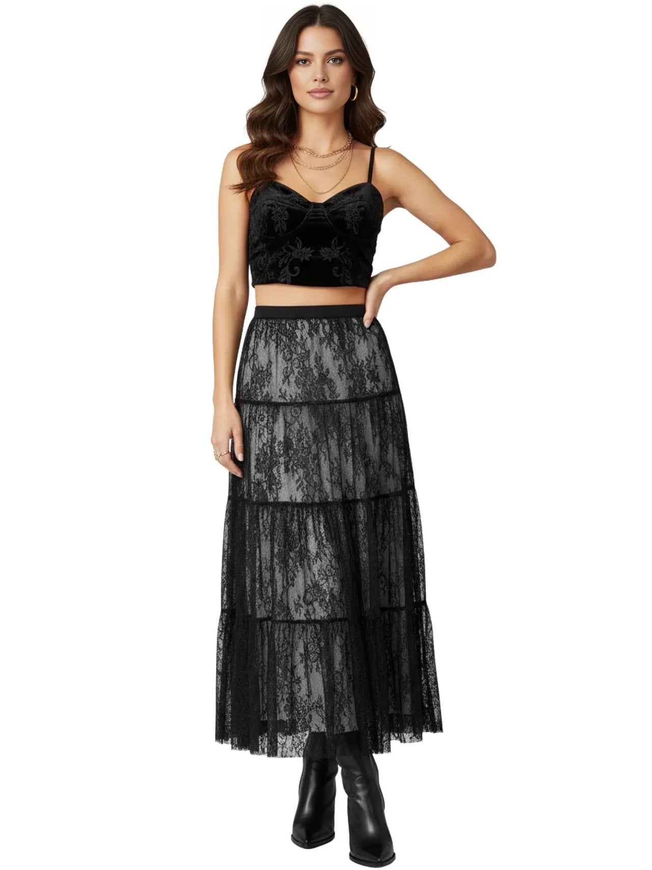 Woman wearing a black lace maxi skirt with a white background