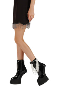 Thumbnail for Black platform boots with pearl detailing worn by a person on a white background