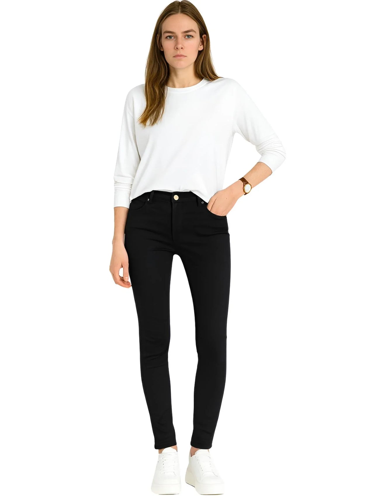 Woman wearing a white top and black skinny jeans on a white background