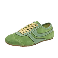 Thumbnail for Green leather sneaker with yellow laces on a white background