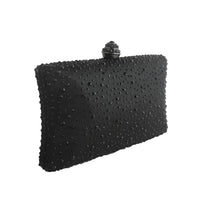 Thumbnail for Black clutch bag with textured surface and decorative clasp on a white background
