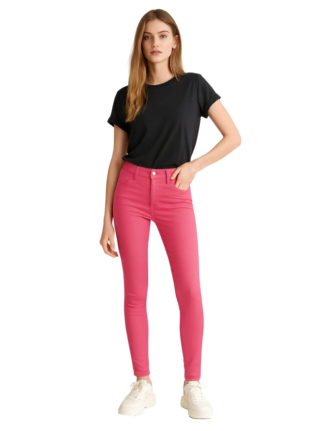 Woman wearing deep pink skinny jeans and a black t-shirt on a white background