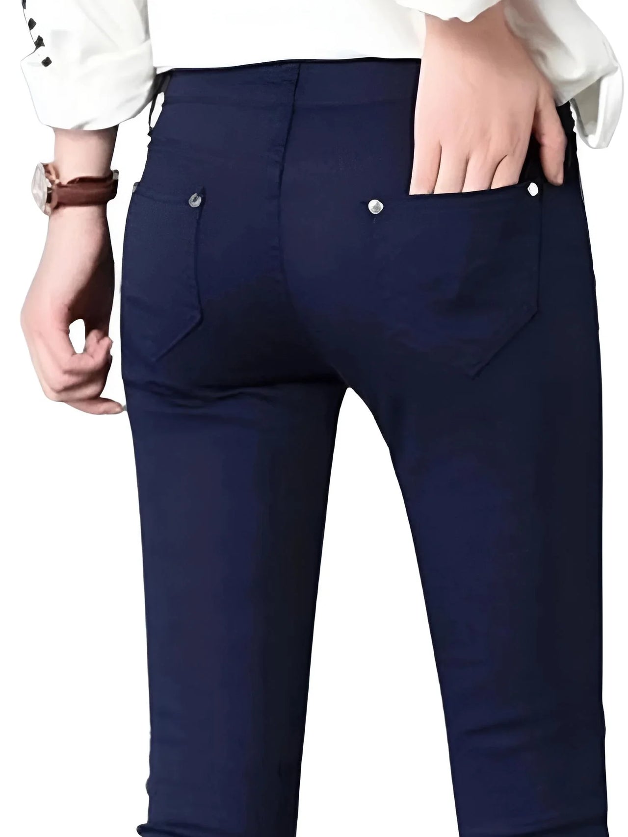 Dark blue skinny jeans worn by a person on a white background