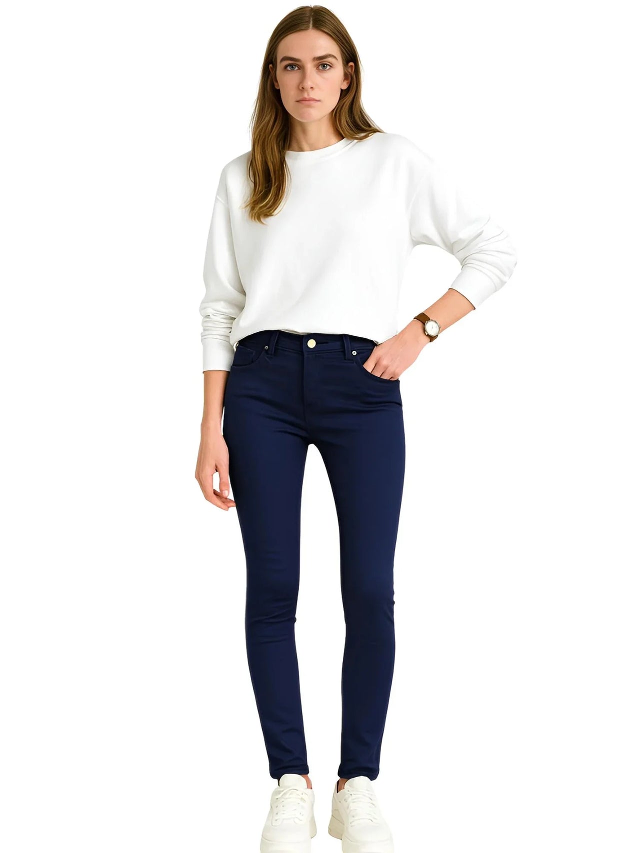 Woman wearing a white sweater and dark blue skinny jeans on a white background