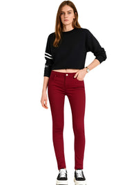 Thumbnail for Woman wearing a black cropped sweater and red jeans on a white background