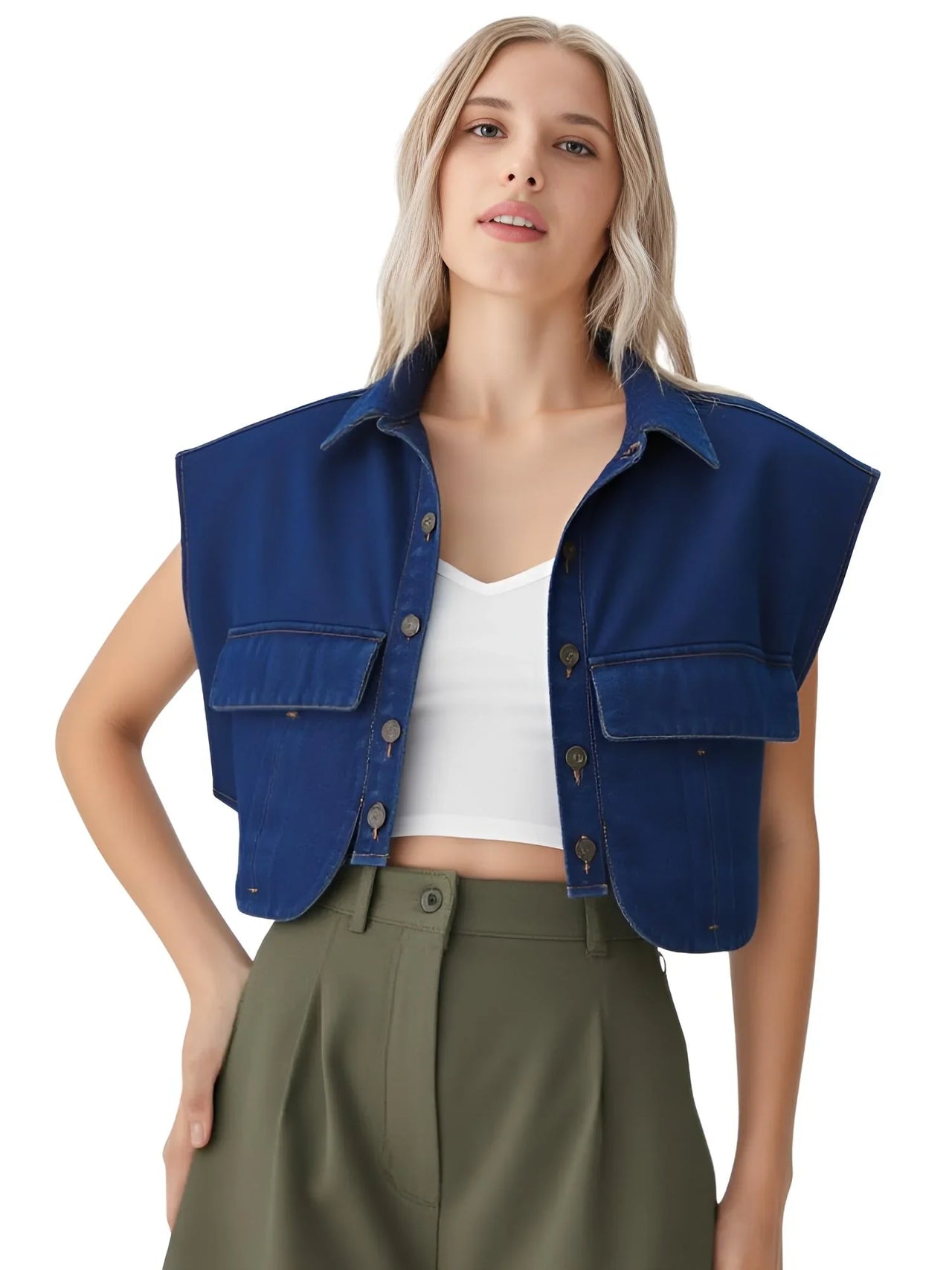 Woman wearing a dark blue denim top over a white top and green pants on a white background