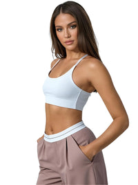 Thumbnail for Woman wearing a white sports bra and khaki flip waist pants on a white background