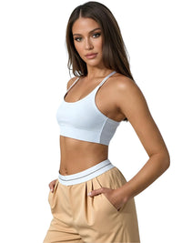 Thumbnail for Woman wearing a white sports bra and gold flip waist pants on a white background