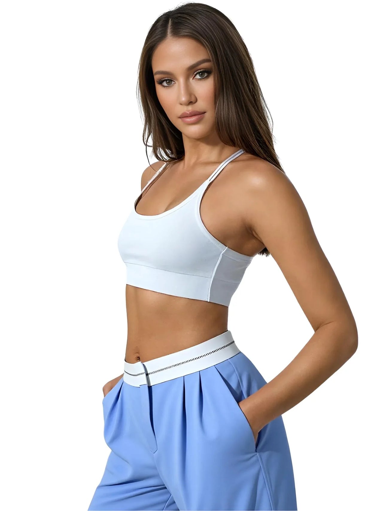 Woman wearing a white sports bra and blue pants on a white background
