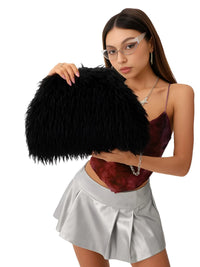 Thumbnail for Woman holding a black fluffy bag against a white background