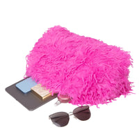 Thumbnail for Pink fluffy pouch with sunglasses, phone, and other items on a white background