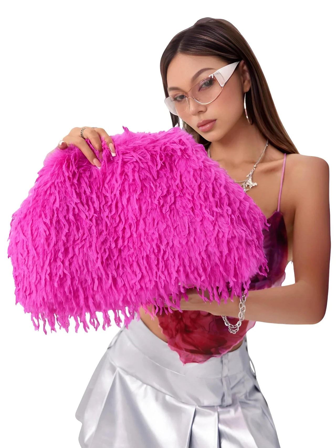 Woman holding a pink fluffy clutch against a white background