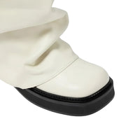 Thumbnail for White slouch boot with a thick black sole on a white background