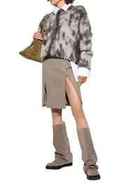 Thumbnail for Person wearing a tie-dye sweater, beige skirt, and brownknee-high slouch boots on a white background