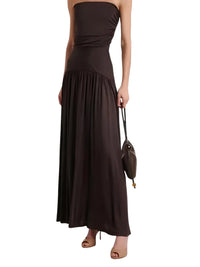 Thumbnail for Woman wearing a brown strapless dress holding a matching handbag on a white background