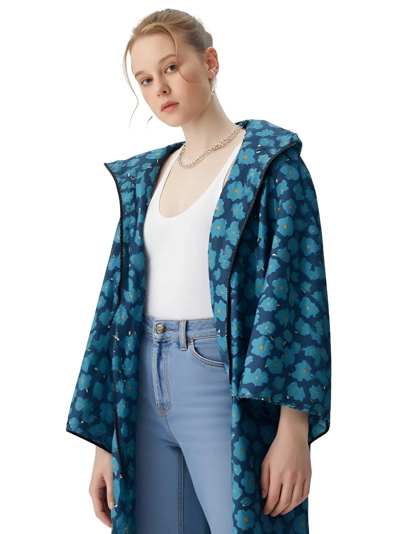 Woman wearing a blue floral-patterned raincoat on a white background