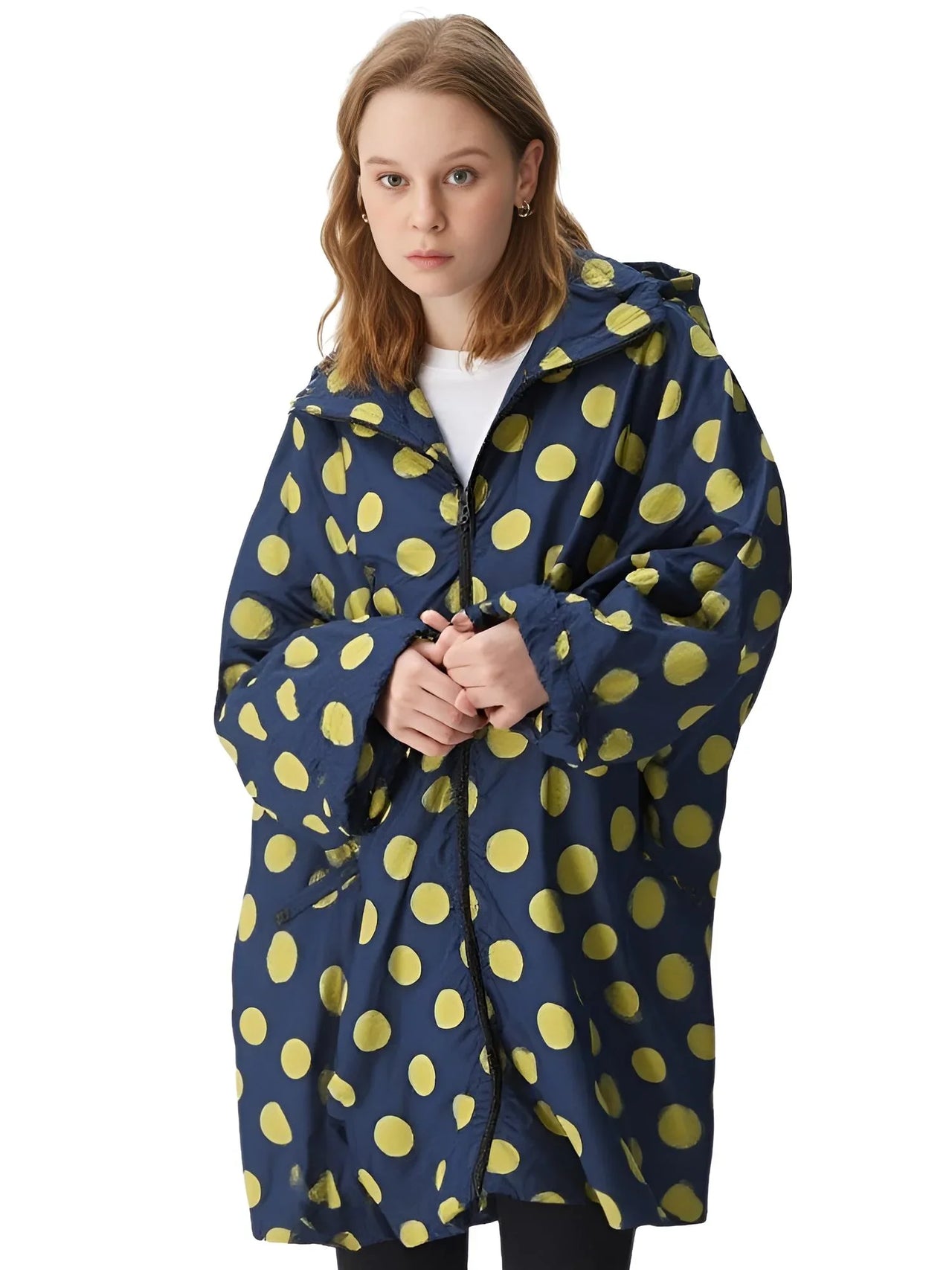 Person wearing a blue raincoat with yellow polka dots on a white background