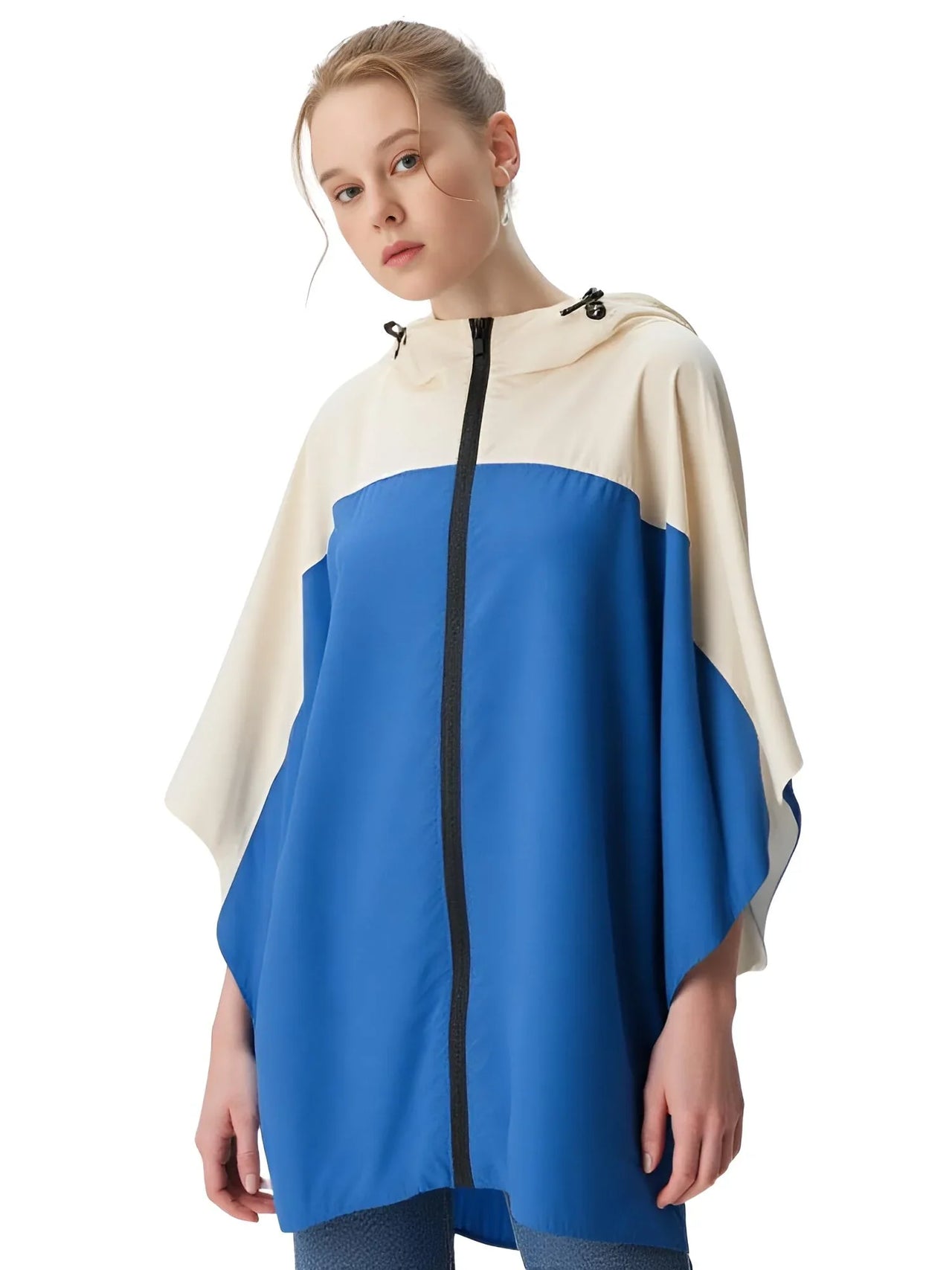 Woman wearing a blue and white poncho on a white background