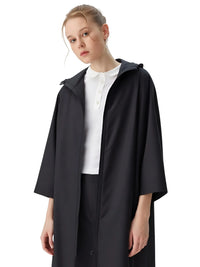 Thumbnail for Person wearing a black raincoat over a white shirt on a white background