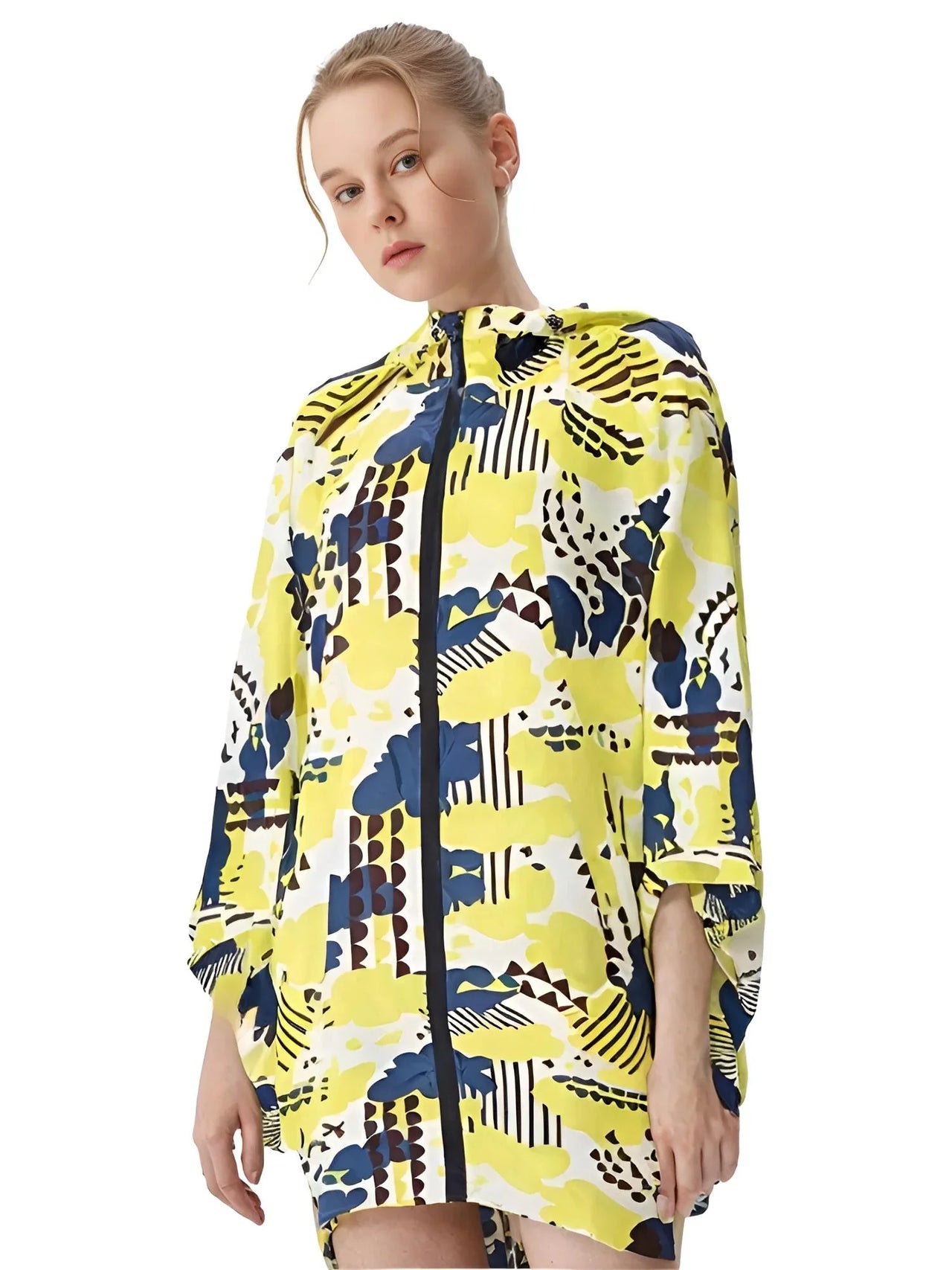 Woman wearing a colorful patterned hooded raincoat on a white background