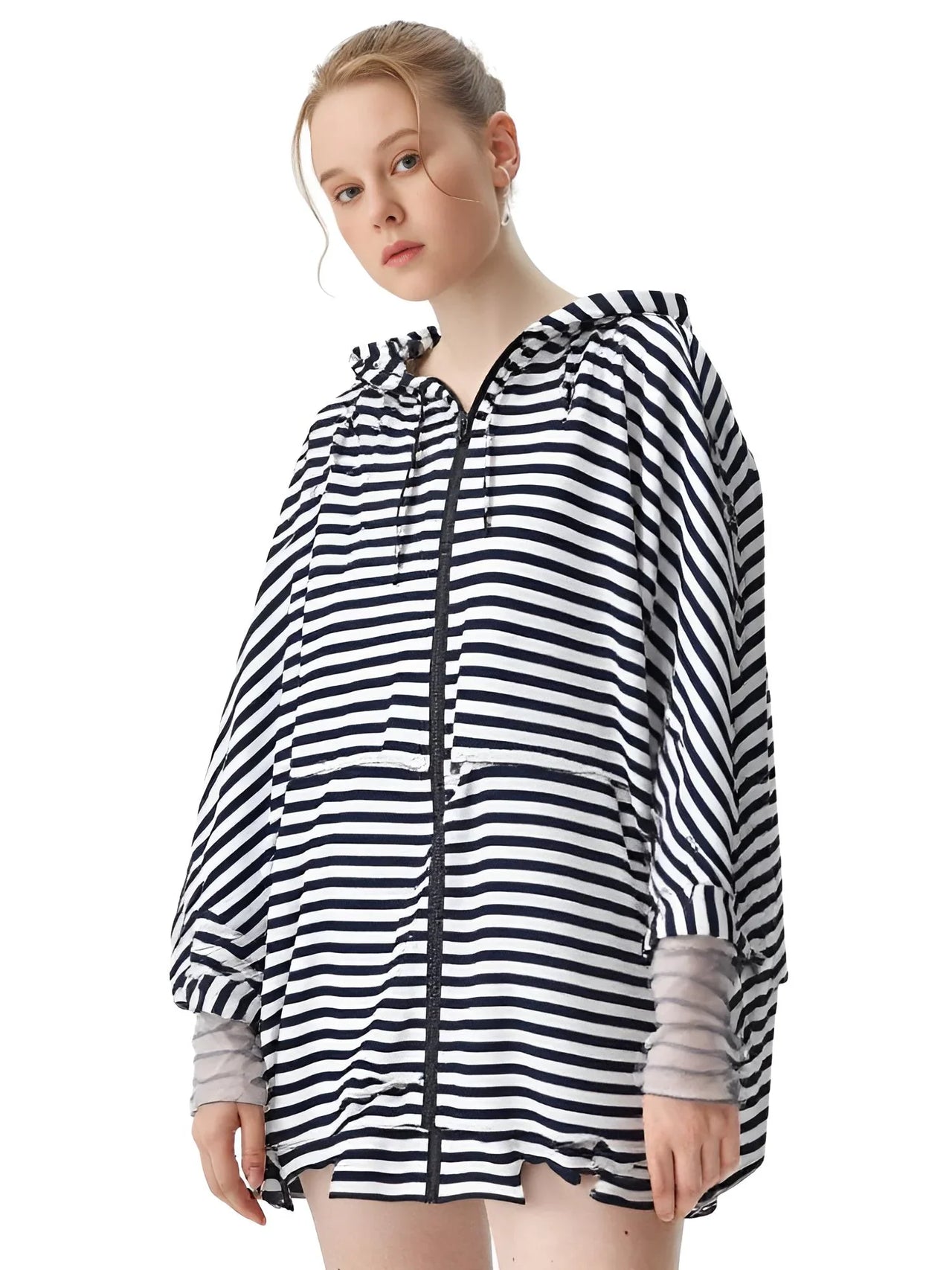 Person wearing a black and white striped raincoat on a white background