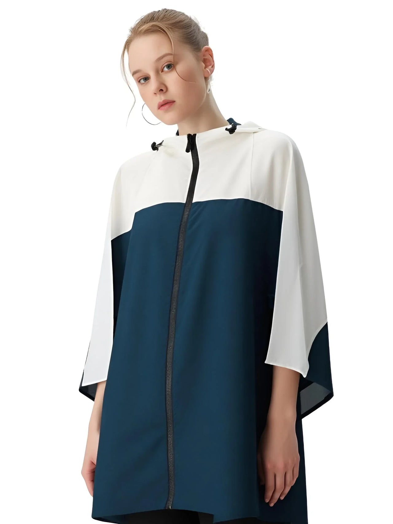 Woman wearing a white and navy blue raincoat on a white background