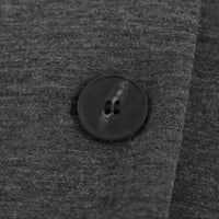 Thumbnail for Close-up of a black button on gray fabric
