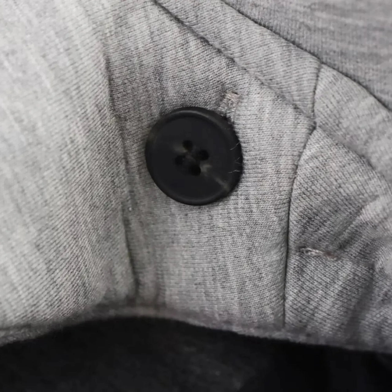 Close-up of a button on gray fabric