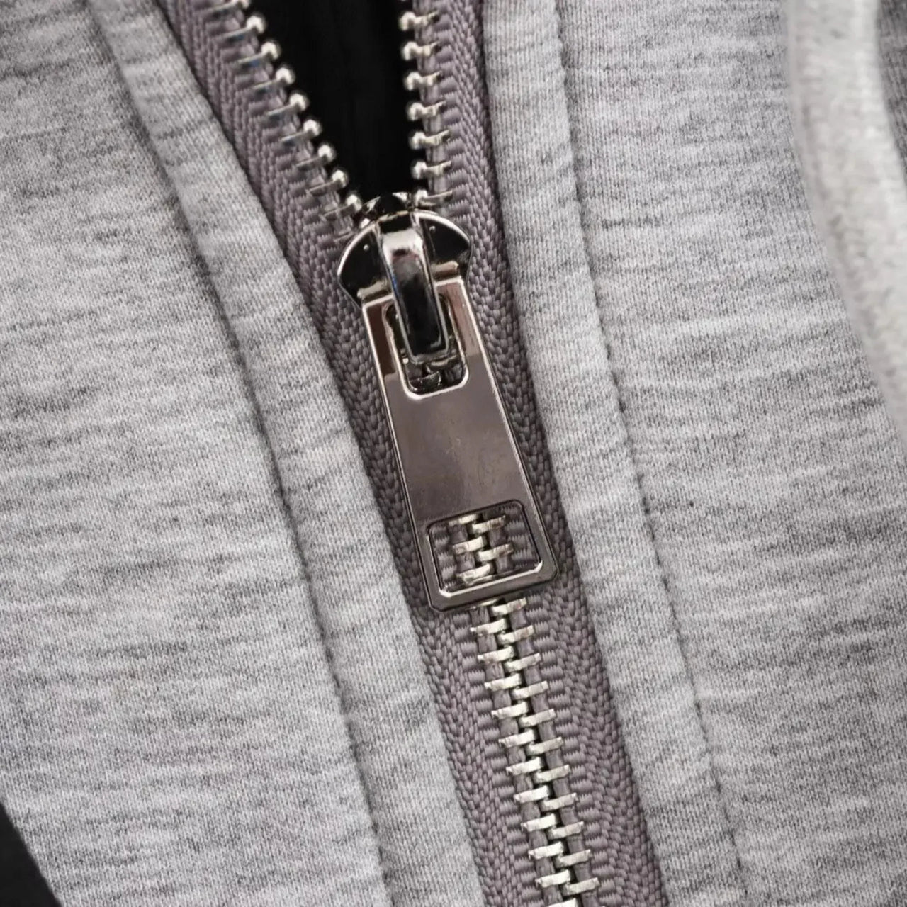 Close-up of a zipper on a gray fabric background