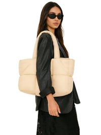 Thumbnail for Woman carrying a khaki puffer bag on a white background