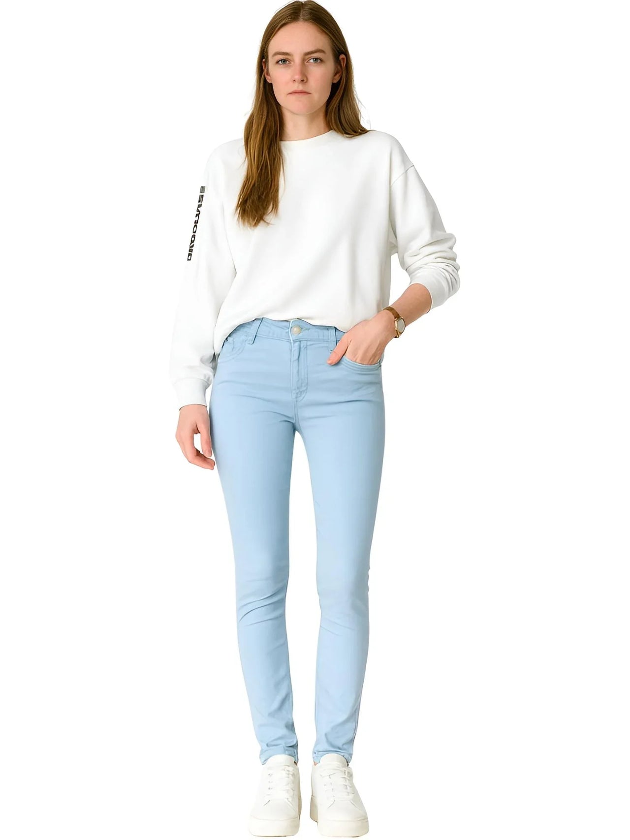 Woman wearing a white sweatshirt and light blue skinny jeans on a white background