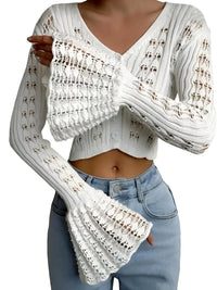 Thumbnail for Person wearing a white flare sleeve cardigan with light blue jeans on a white background