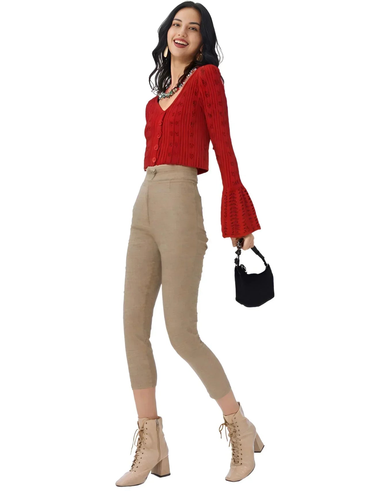 Woman wearing a red crop sweater, beige pants, and beige boots on a white background