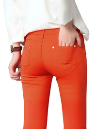 Thumbnail for Person wearing bright orange skinny jeans with a white shirt on a white background