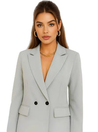Thumbnail for Woman wearing a pale green blazer with a plain background